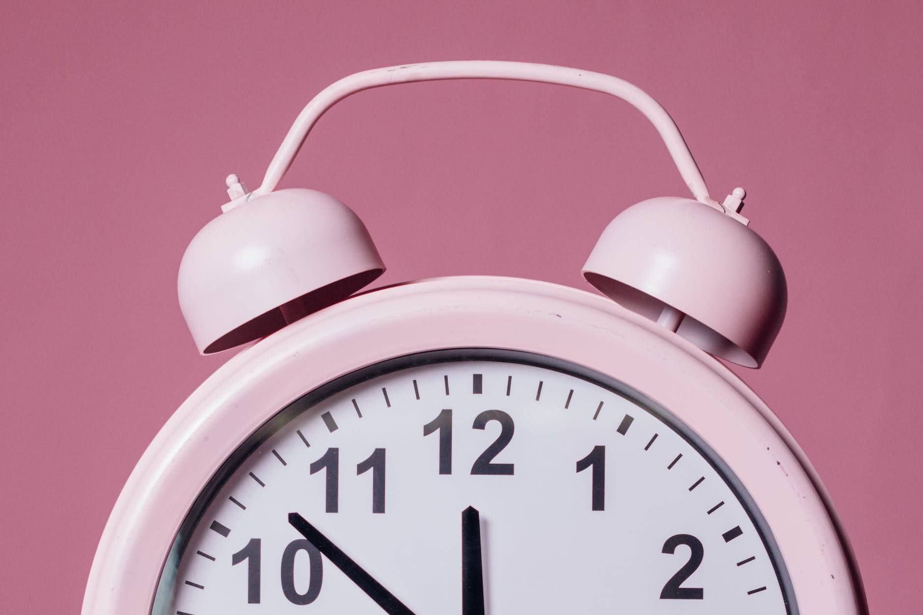 close up photo of pink alarm clock