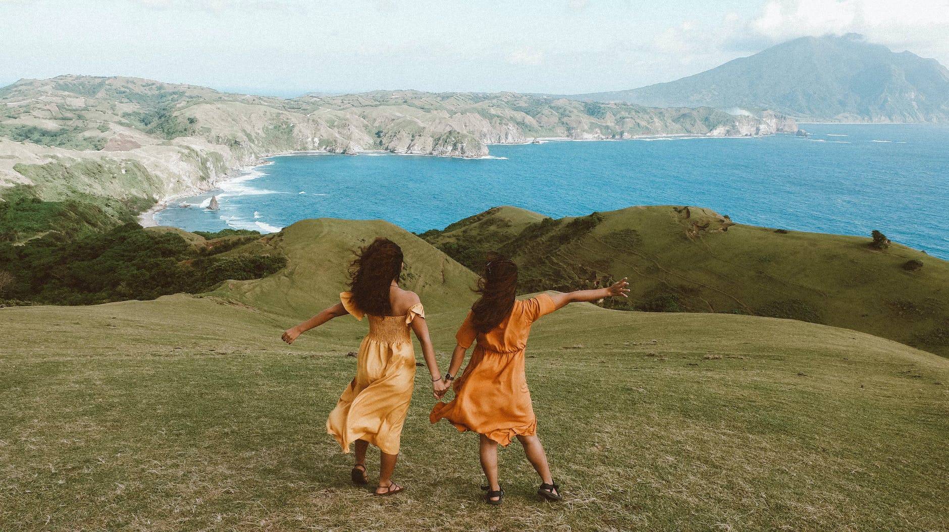 women holding hands and looking at view